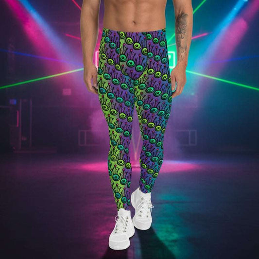 Man from the waist down wearing men's jungle tribal frog funky festival yoga leggings standing facing forwards with his hands by his sides. He is wearing white trainers and is standing on a nightclub dance floor with colourful neon light spots around him. The jungle tribal frog pattern is an abstract pattern with a blended green and purple background.
