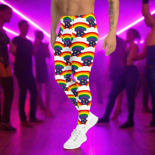 Man from the waist down wearing men's Rainbow Sparkle funky festival yoga leggings standing facing to the left with his hands by his sides. The man is standing in a nightclub with colourful pink lighting and other club goers in the background. The rainbow sparkle pattern features repeating rainbows and white fluffy clouds with three small yellow stars beneath each rainbow. The background colour is navy blue