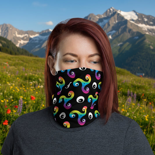 Woman wearing a Trippy Triskelion neck gaiter as a face covering with a summer Alps background