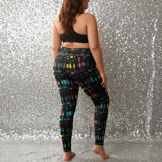 High waist Plus Size Minstrel Magic festival yoga leggings back view. Woman is standing in a boho interior room. The Minstrel Magic design is a bold colourful rainbow tie-dye inspired design. Designed in Wales, UK | Sassy Seagull.