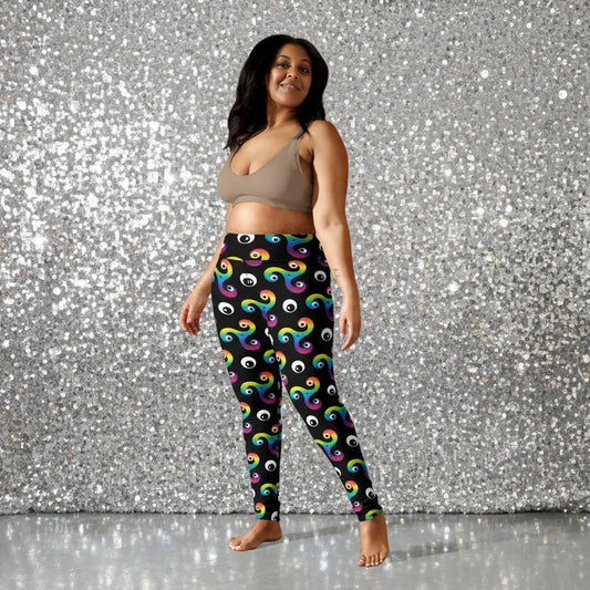 High waist plus size black psychedelic celtic inspired Trippy Triskelion patterned festival & yoga leggings lifestyle view against a silver sequin background. The Trippy Triskelion print is a trippy rainbow geometric printed pattern. Designed in Wales, UK | Sassy Seagull.