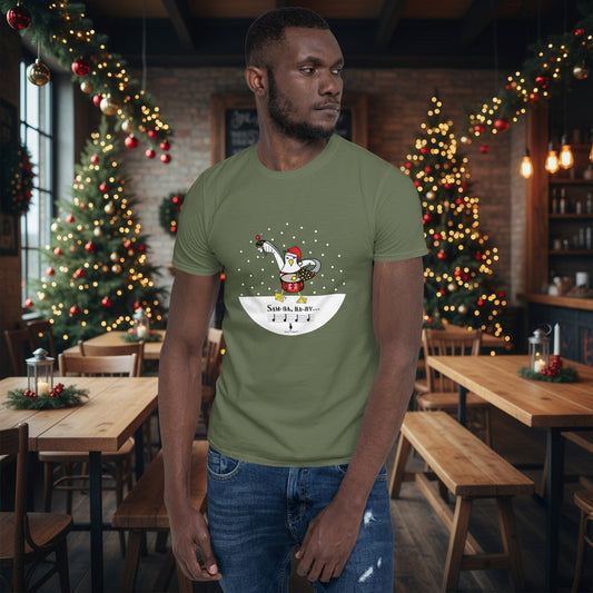 Man wearing a khaki green 100% cotton samba drumming seagulll in the snow Christmas t-shirt with the text Samba Baby in a rustic cafe filled with red, green and gold Christmas decorations