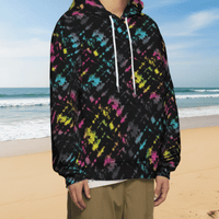 Man from the chin down to the waist, posing standing facing to the right wearing a 100% cotton vibrant Minstrel Magic tie-dye all-over print hoodie. He is standing outside amongst autumnal trees with golden leaves blanketing the ground. The hoodie is black with splashes of bright pink, orange yellow, green, blue and grey. It is a bold fun design for everyday wear.