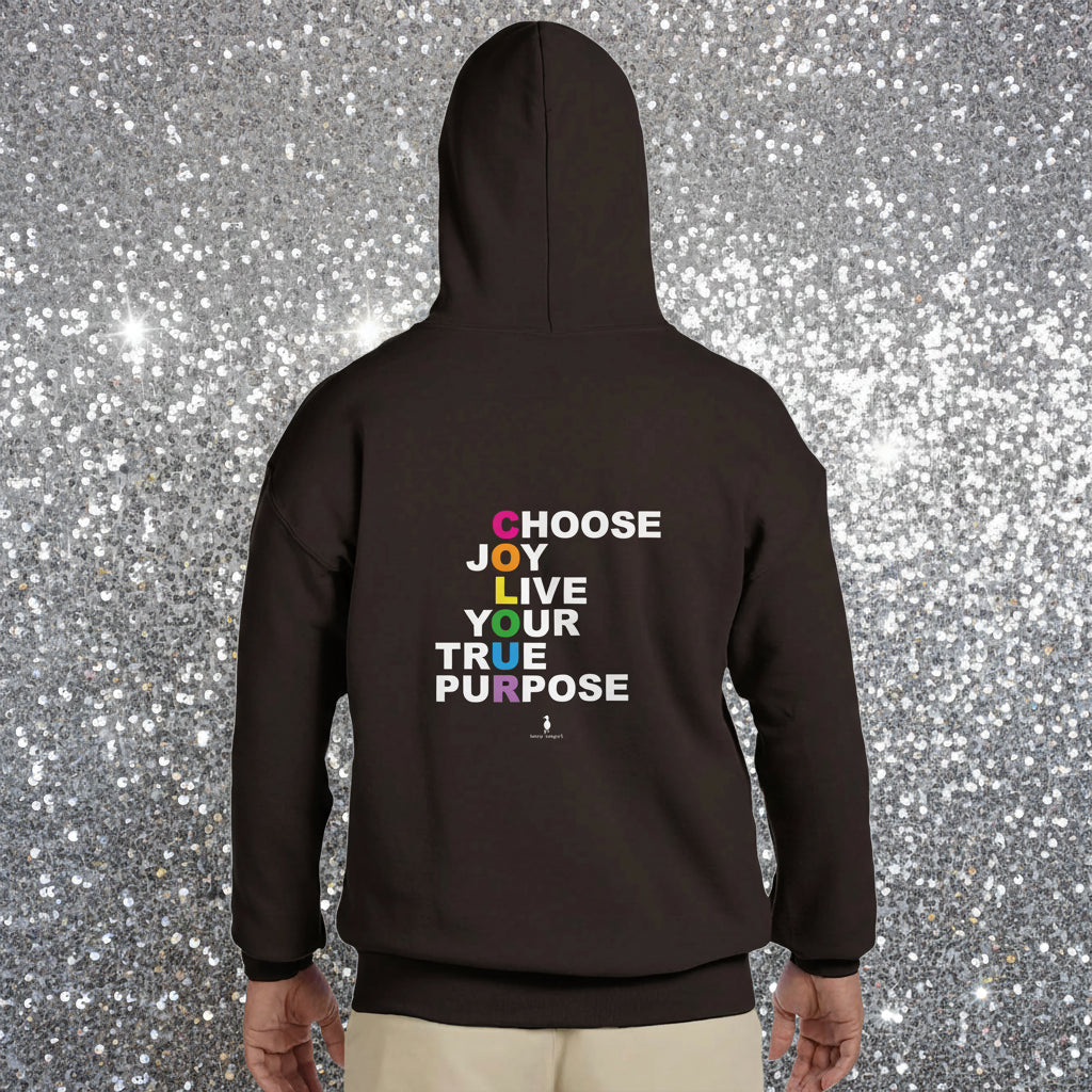 Person wearing a black Choose Joy hoodie facing away in a colourful boho cafe.