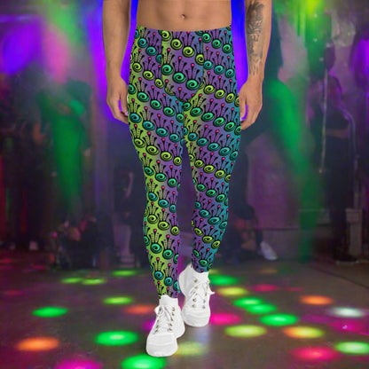 Man from the waist down wearing men's jungle tribal frog funky festival yoga leggings standing facing forwards with his hands by his sides. He is wearing white trainers and is standing on a nightclub dance floor with colourful neon light spots around him. The jungle tribal frog pattern  is an abstract pattern with a blended green and purple background.