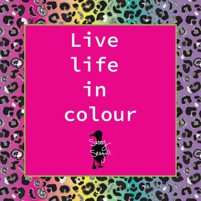 Motivational-poster-with-'Live-life-in-colour'-text-on-a-pink-square,-surrounded-by-a-multicolored-leopard-print-border.