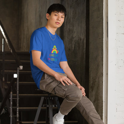 Man wearing a royal blue 100% cotton vibrant, rainbow live life in colour t-shirt in a modern industrial interior.