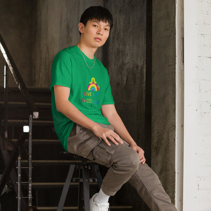 Man wearing a green 100% cotton vibrant, rainbow live life in colour t-shirt in a modern industrial interior.