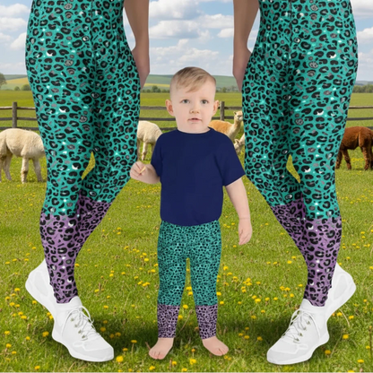 Two men and a toddler wearing matching festival leggings designed in Wales - bold Purple and Green Leopard Glamour pattern. Silver Sequin background | Sassy Seagull