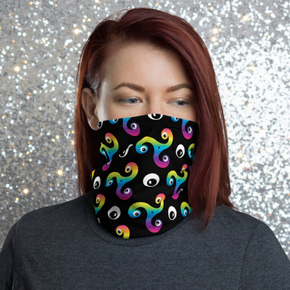 Woman wearing a Trippy Triskelion neck gaiter as a face covering with a summer Alps background