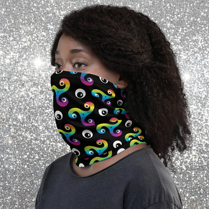 Woman wearing a Trippy Triskelion neck gaiter as a face covering facing to the left in a city park.