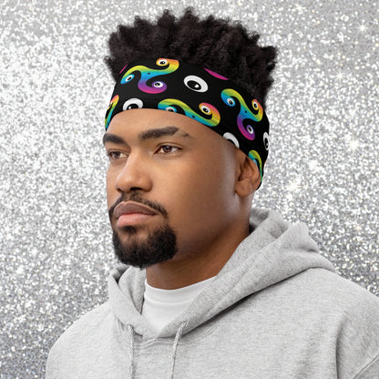 Man wearing a Trippy Triskelion neck gaiter as a headband at a skate park.