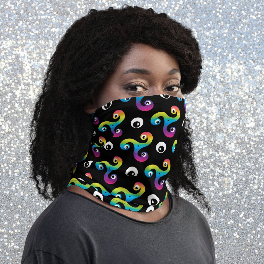 Woman wearing a Trippy Triskelion neck gaiter as a face covering in the snowy mountains.