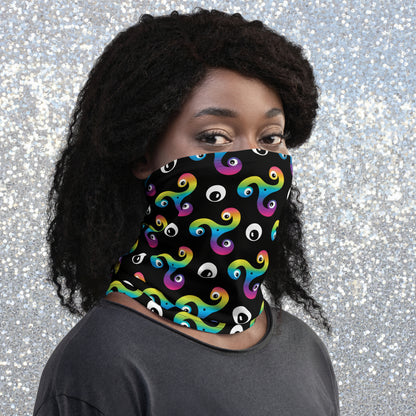 Woman wearing a Trippy Triskelion neck gaiter as a face covering in the snowy mountains.