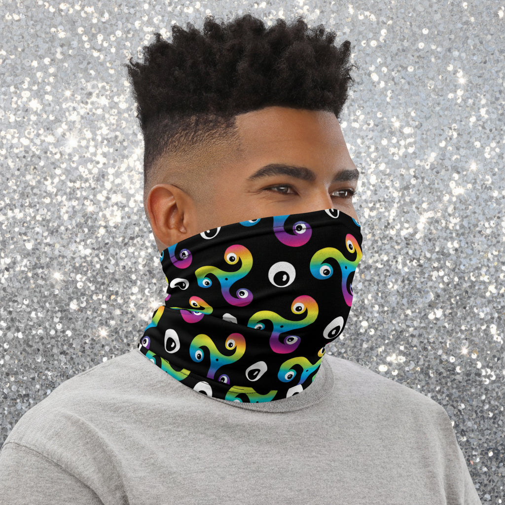 Man wearing a Trippy Triskelion neck gaiter as a face covering, facing to the right outside a biker cafe