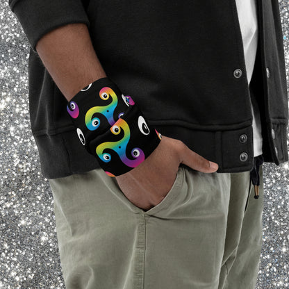 Person wearing a Trippy Triskelion neck gaiter as a wristband at a festival or club night.