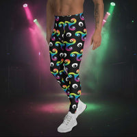 Man from the waist down wearing Trippy Triskelion leggings facing to the left in a nightclub environment with purple and green lights
