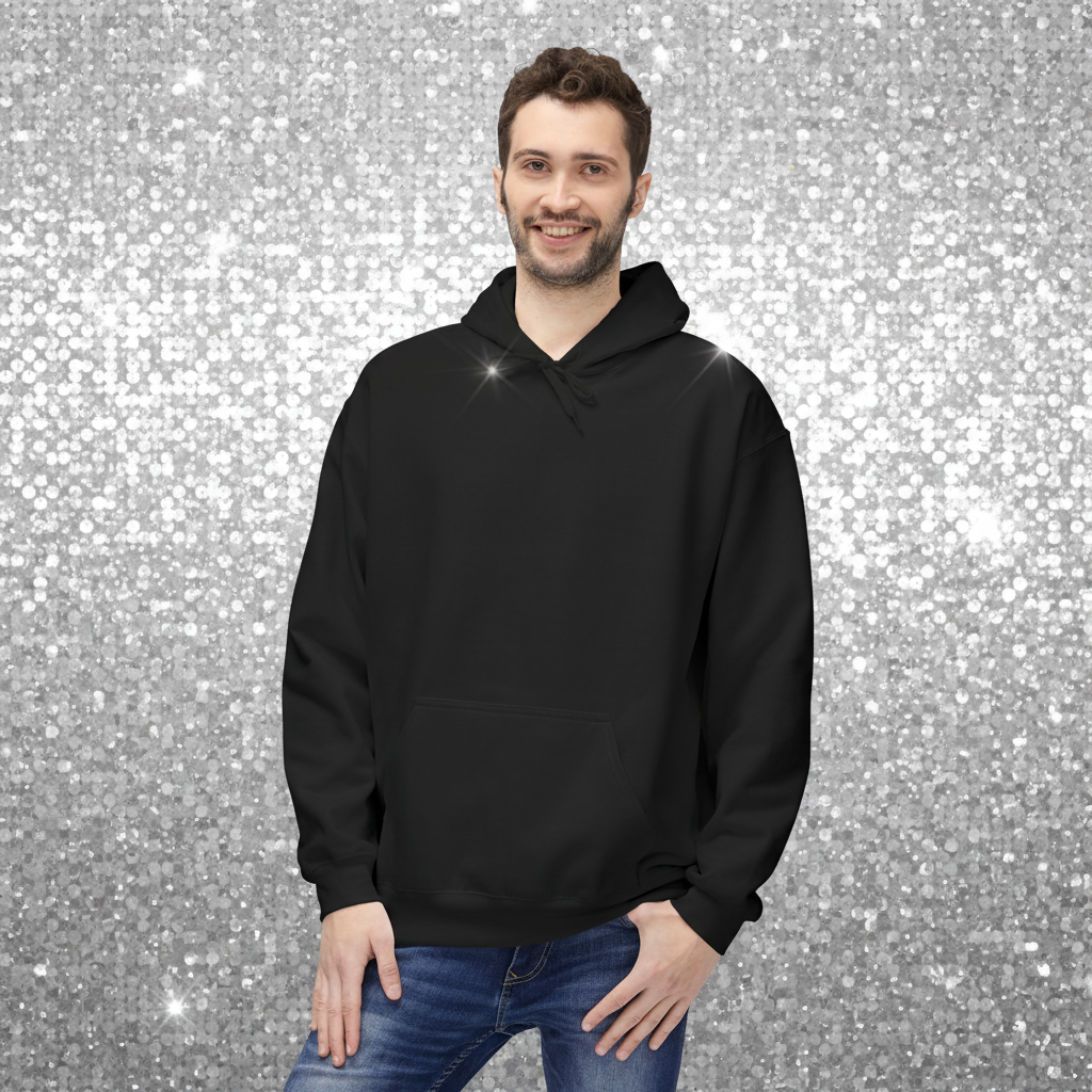 Man facing forward wearing a black hoodie with a plain front. He is standing in a cosy boho cafe filled with plants and wooden tables.
