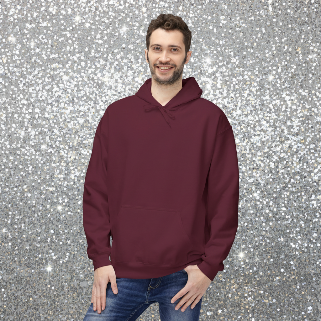 Man facing forward wearing a maroon hoodie with a plain front. He is standing in a cosy boho cafe filled with plants and wooden tables.
