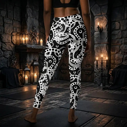 Women's high waist black and white yoga festival leggings back view. Woman is posing in a heavy metal yoga studio.  The Who's Afraid Of The Dark design is a bold abstract pattern. Designed in Wales, UK | Sassy Seagull. 
