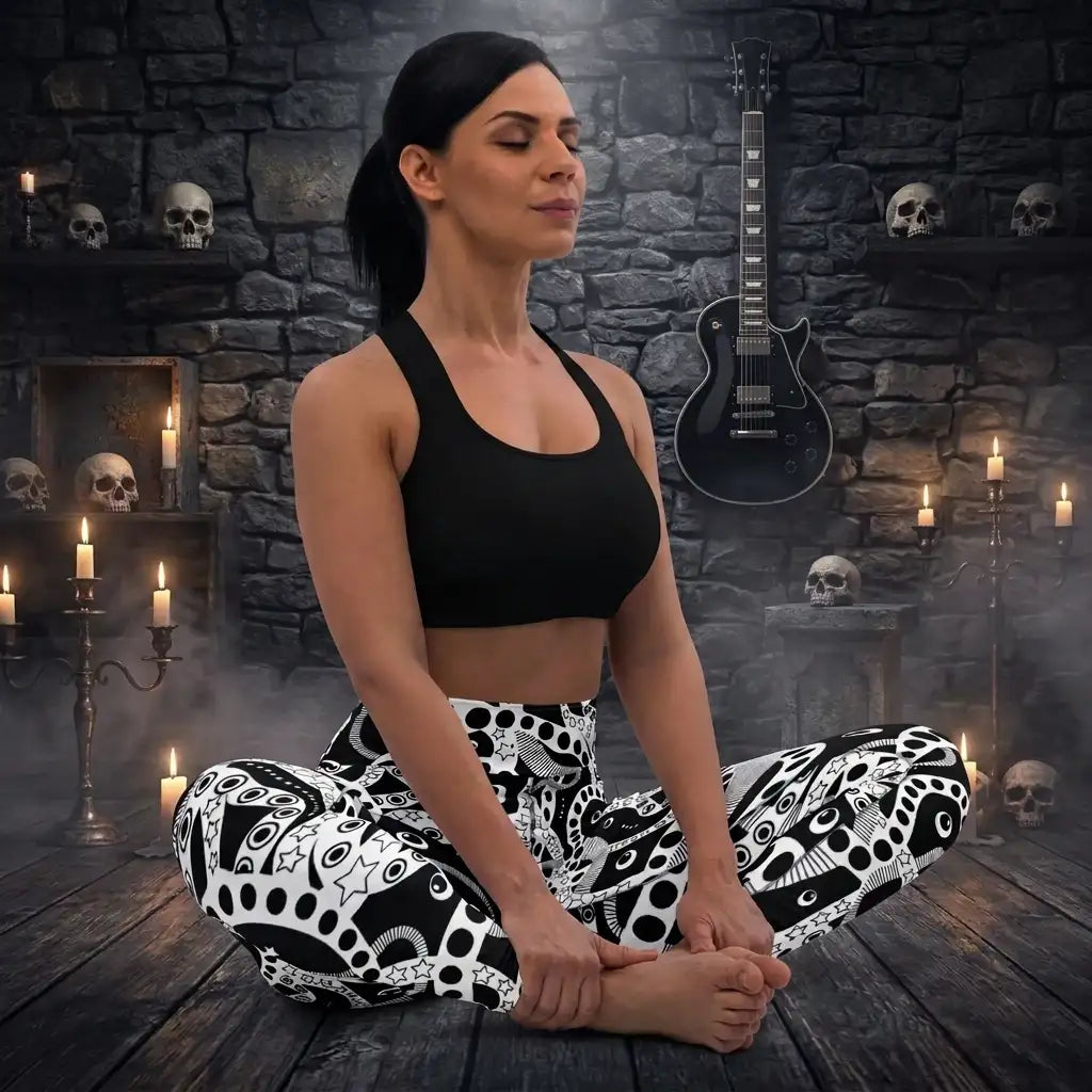 Women's high waist black and white yoga festival leggings lifestyle yoga view. Woman is posing in a heavy metal yoga studio.  The Who's Afraid Of The Dark design is a bold abstract pattern. Designed in Wales, UK | Sassy Seagull. 