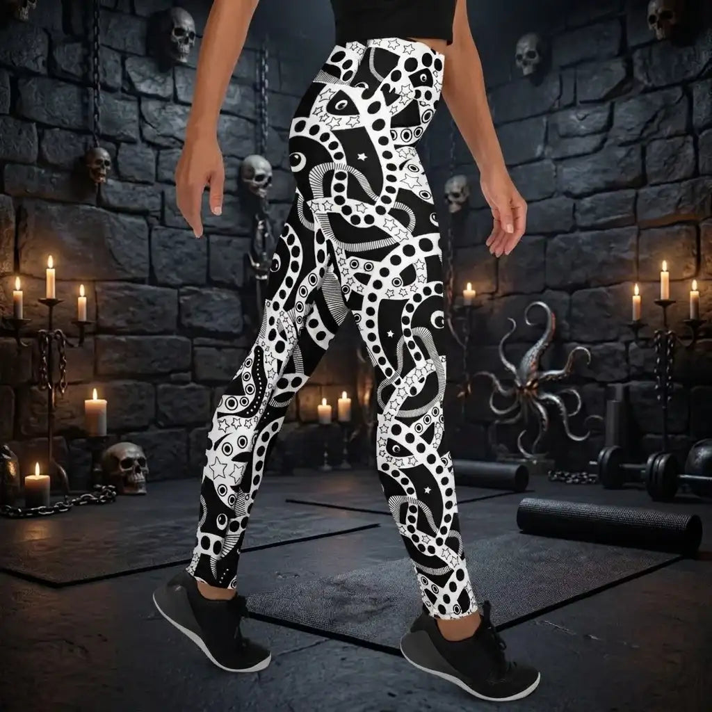 Women's high waist black and white yoga festival leggings side view. Woman is posing in a heavy metal yoga studio.  The Who's Afraid Of The Dark design is a bold abstract pattern. Designed in Wales, UK | Sassy Seagull. 