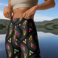 High waist Black Paisley Party festival yoga leggings close up front view. Woman is standing in a boho interior room.  The Paisley Party design is a bold colourful rainbow geometric print pattern. Designed in Wales, UK | Sassy Seagull. 