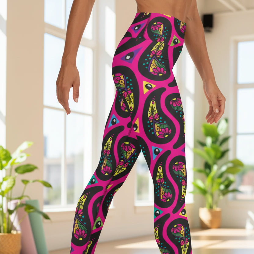 High waist Pink Paisley Party festival yoga leggings side view. Woman is standing in front of a shimmery silver sequin backdrop.  The Paisley Party design is a bold colourful rainbow geometric print pattern. Designed in Wales, UK | Sassy Seagull. 