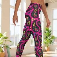 High waist Pink Paisley Party festival yoga leggings side view. Woman is standing in front of a shimmery silver sequin backdrop.  The Paisley Party design is a bold colourful rainbow geometric print pattern. Designed in Wales, UK | Sassy Seagull. 