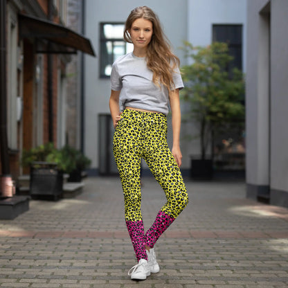 High waist Pink and Yellow Leopard Glamour festival yoga leggings lifestyle view in an outdoor setting. The pink and yellow leopard glamour design is a bold animal printed pattern in black, grey and white against a bold yellow and pink background. Designed in Wales, UK | Sassy Seagull. 