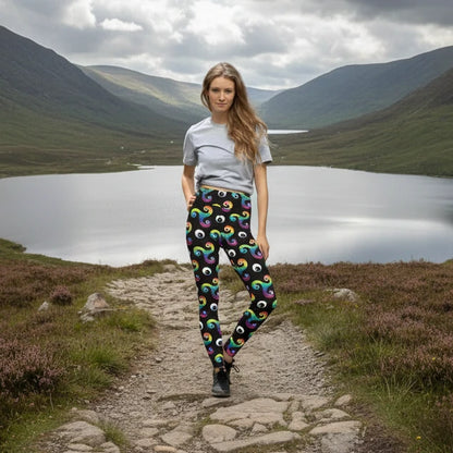 High waist black psychedelic celtic inspired Trippy Triskelion patterned festival & yoga leggings lifestyle view against a silver sequin background. The Trippy Triskelion print is a trippy rainbow geometric printed pattern. Designed in Wales, UK | Sassy Seagull. 