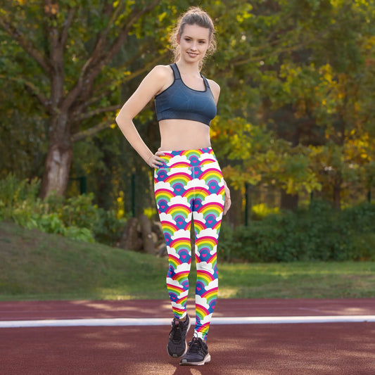 High waist Rainbow Love festival yoga leggings lifestyle view. The woman is standing in an outdoor sports setting.  The Rainbow Love design is a bold design featuring rainbows, white clouds and pink hearts. Designed in Wales, UK | Sassy Seagull. 