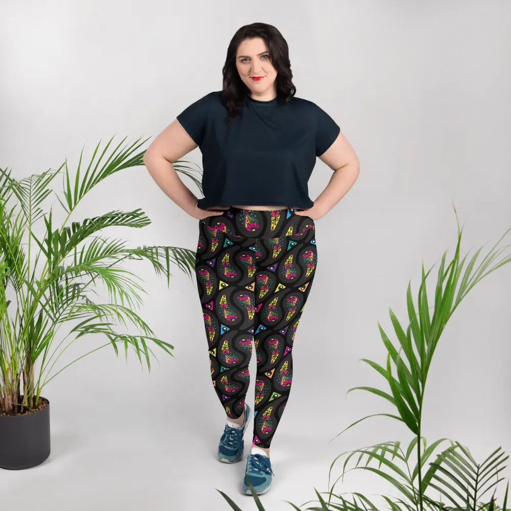 High waist Plus Size Black Paisley Party festival yoga leggings lifestyle view. Woman is standing in an interior setting.  The Paisley Party design is a bold colourful rainbow geometric print pattern. Designed in Wales, UK | Sassy Seagull. 