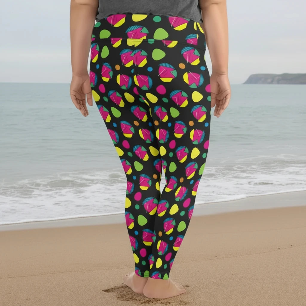 Plus-size high waist Funk Party Original festival yoga leggings back view. The woman is standing in a rustic boho setting with plants, fairy lights and bunting in the background.  The Funk Party design is a bold colourful abstract print. Designed in Wales, UK | Sassy Seagull. 