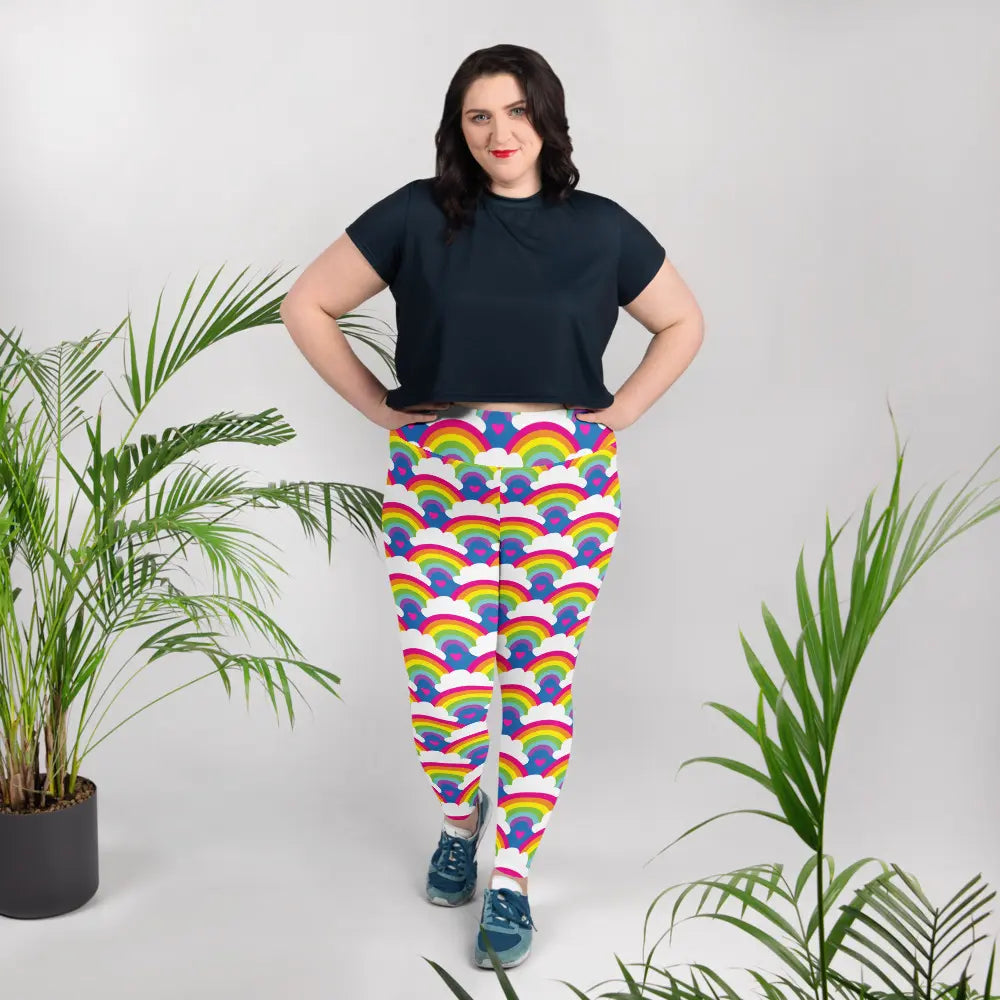 High waist Rainbow Love festival yoga leggings lifestyle view. The woman is standing in an indoor setting.  The Rainbow Love design is a bold design featuring rainbows, white clouds and pink hearts. Designed in Wales, UK | Sassy Seagull. 