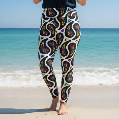High waist Plus Size White Paisley Party festival yoga leggings left view. Woman is standing in a boho interior room.  The Paisley Party design is a bold colourful rainbow geometric print pattern. Designed in Wales, UK | Sassy Seagull. 