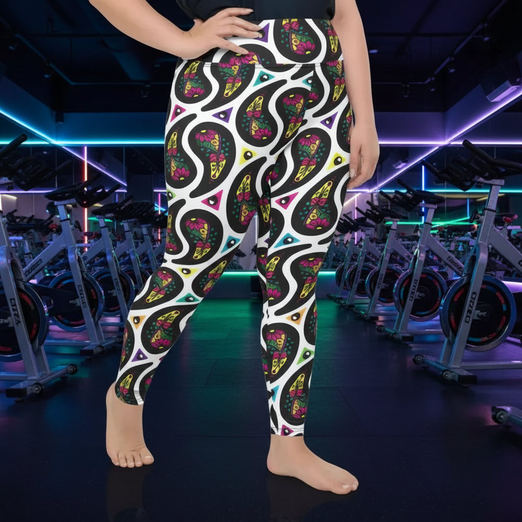 High waist Plus Size White Paisley Party festival yoga leggings right view. Woman is standing in a boho interior room.  The Paisley Party design is a bold colourful rainbow geometric print pattern. Designed in Wales, UK | Sassy Seagull. 