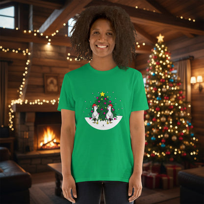 Person wearing an Irish green 100% cotton Christmas t-shirt with two sassy seagulls in front of a decorated Christmas tree. The person is standing in a wooden chalet decorated for Christmas.