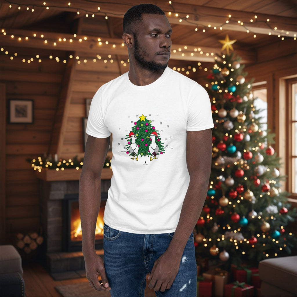 Person wearing a white 100% cotton Christmas t-shirt with two sassy seagulls in front of a decorated Christmas tree. The person is standing in a wooden chalet decorated for Christmas.
