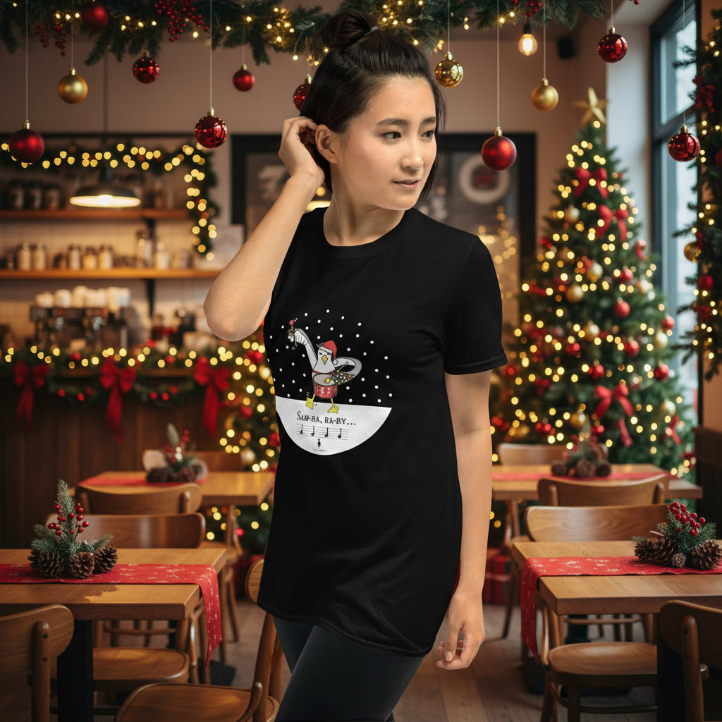 Woman wearing a black 100% cotton samba drumming seagulll in the snow Christmas t-shirt with the text Samba Baby in a rustic cafe filled with red, green and gold Christmas decorations