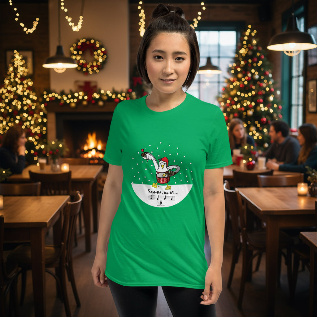 Woman wearing an Irish green 100% cotton samba drumming seagulll in the snow Christmas t-shirt with the text Samba Baby in a rustic cafe filled with red, green and gold Christmas decorations