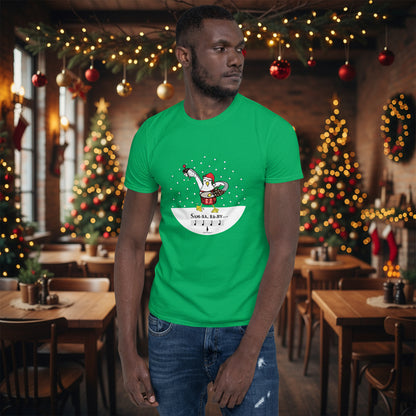 Man wearing an Irish green 100% cotton samba drumming seagulll in the snow Christmas t-shirt with the text Samba Baby in a rustic cafe filled with red, green and gold Christmas decorations