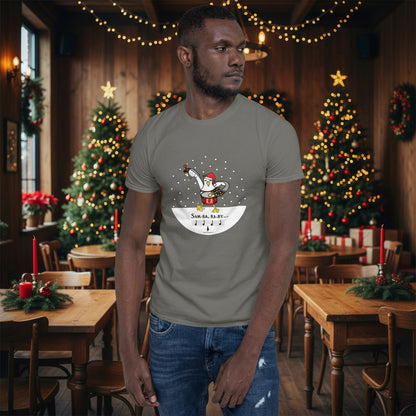 Man wearing a charcoal grey 100% cotton samba drumming seagulll in the snow Christmas t-shirt with the text Samba Baby in a rustic cafe filled with red, green and gold Christmas decorations
