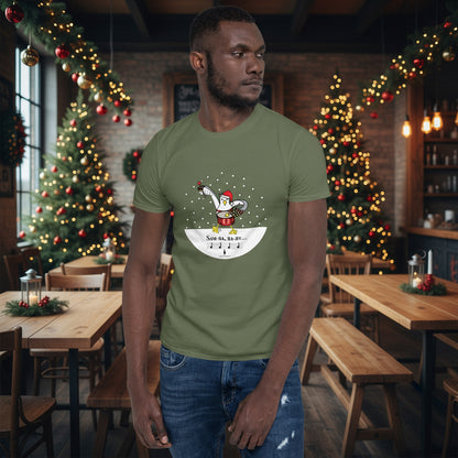 Man wearing a khaki green 100% cotton samba drumming seagulll in the snow Christmas t-shirt with the text Samba Baby in a rustic cafe filled with red, green and gold Christmas decorations