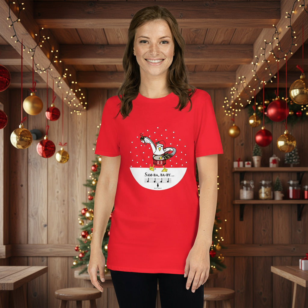 Woman wearing a red 100% cotton samba drumming seagulll in the snow Christmas t-shirt with the text Samba Baby in a rustic cafe filled with red, green and gold Christmas decorations