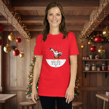 Woman wearing a red 100% cotton samba drumming seagulll in the snow Christmas t-shirt with the text Samba Baby in a rustic cafe filled with red, green and gold Christmas decorations