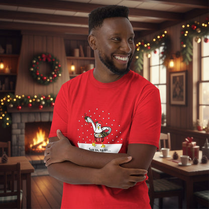 Man wearing a red 100% cotton samba drumming seagulll in the snow Christmas t-shirt with the text Samba Baby in a rustic cafe filled with red, green and gold Christmas decorations