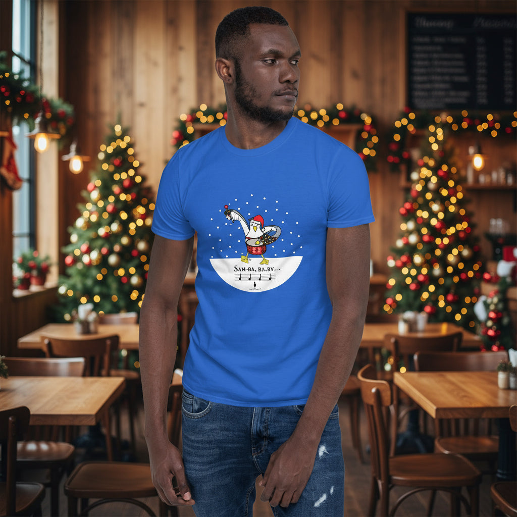 Man wearing a royal blue 100% cotton samba drumming seagulll in the snow Christmas t-shirt with the text Samba Baby in a rustic cafe filled with red, green and gold Christmas decorations