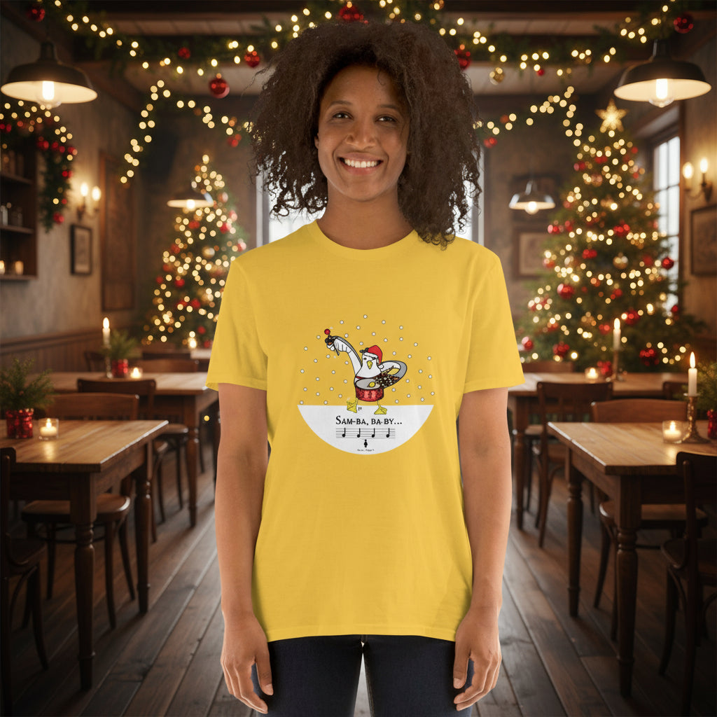 Woman wearing a yellow 100% cotton samba drumming seagulll in the snow Christmas t-shirt with the text Samba Baby in a rustic cafe filled with red, green and gold Christmas decorations