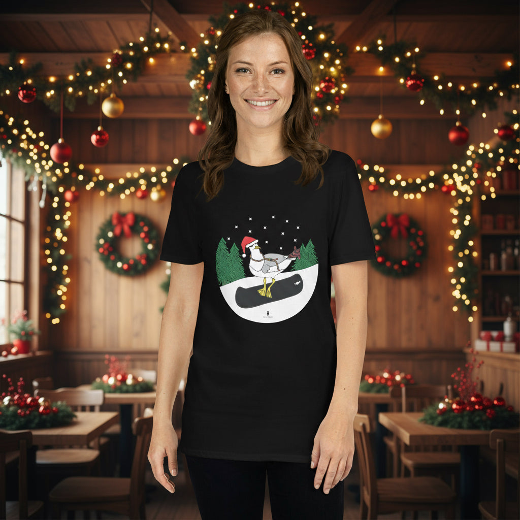 Woman wearing a black 100% cotton snowboarding seagull Christmas t-shirt, in a rustic cafe filled with red, green and gold Christmas decorations